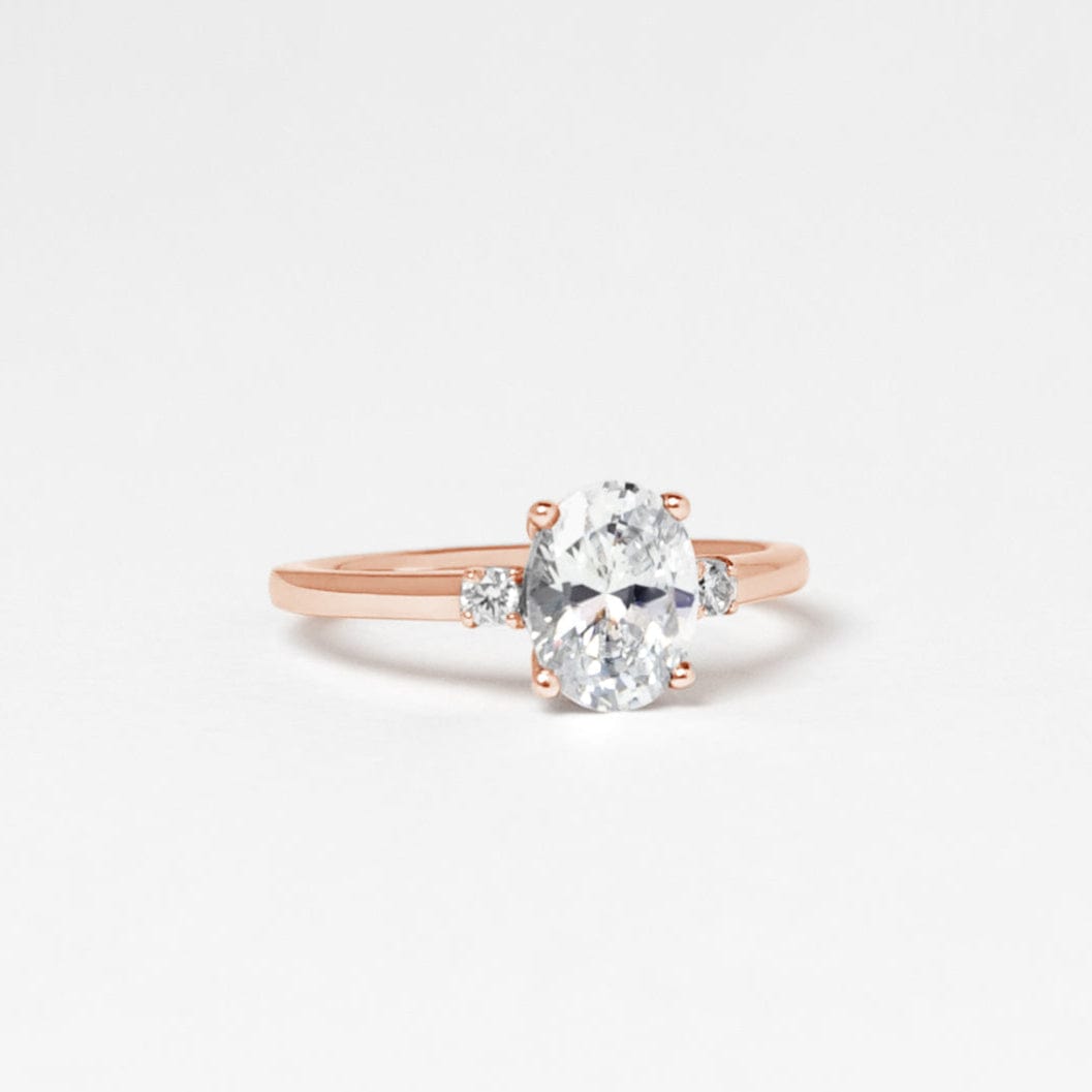 oval moissanite trilogy engagement ring rose gold