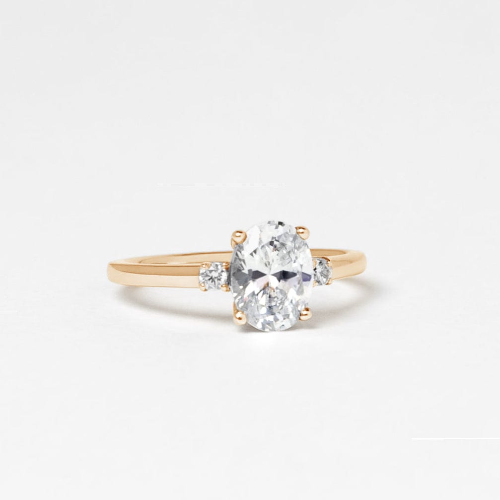 oval moissanite trilogy engagement ring yellow gold